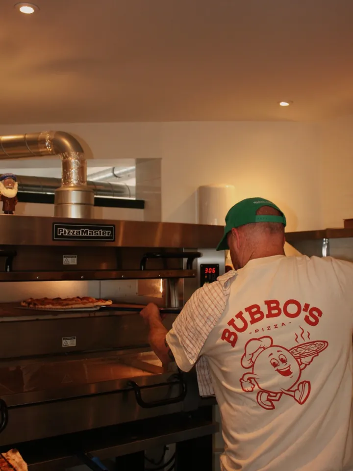 The Bubbo's chef loading the deck oven